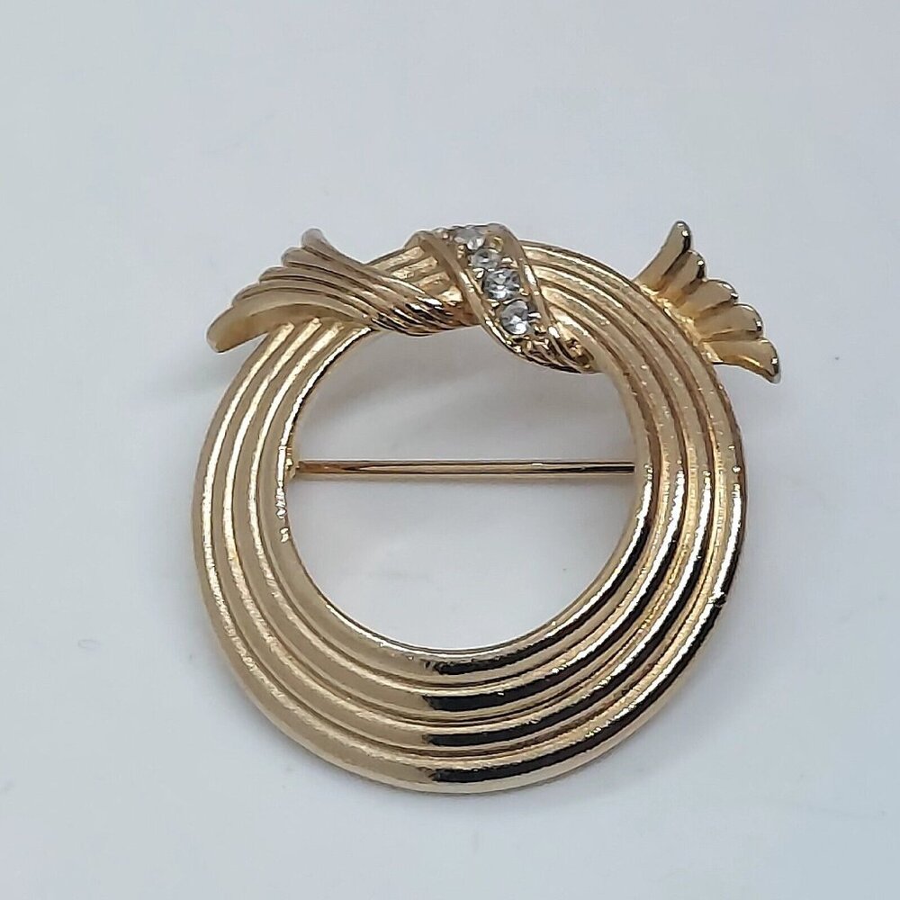 Avon Gold Tone Four Ring Circle Pin with Pavé Wreath on Top